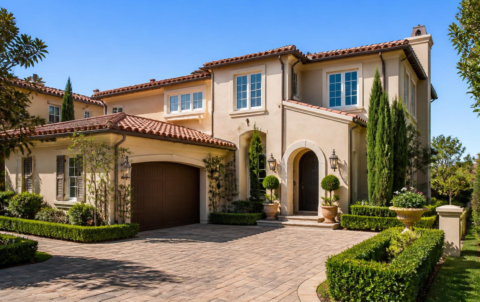 Mediterranean-style two-story home with tile roof and arched entry in the Verona community